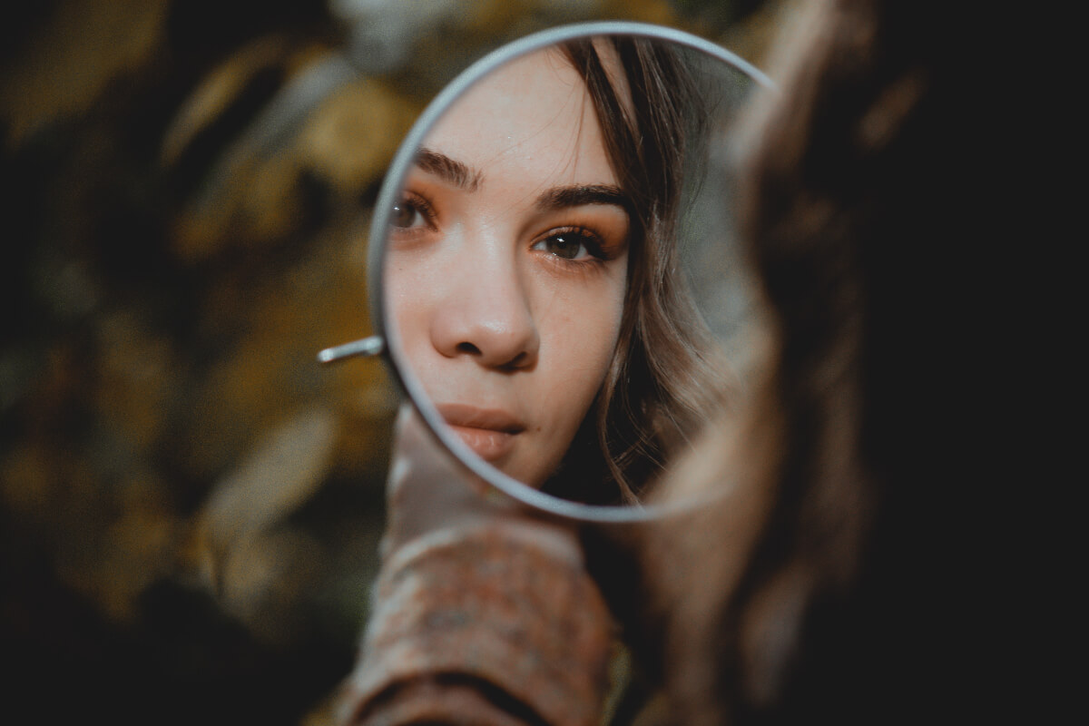 Woman looking into a mirror 