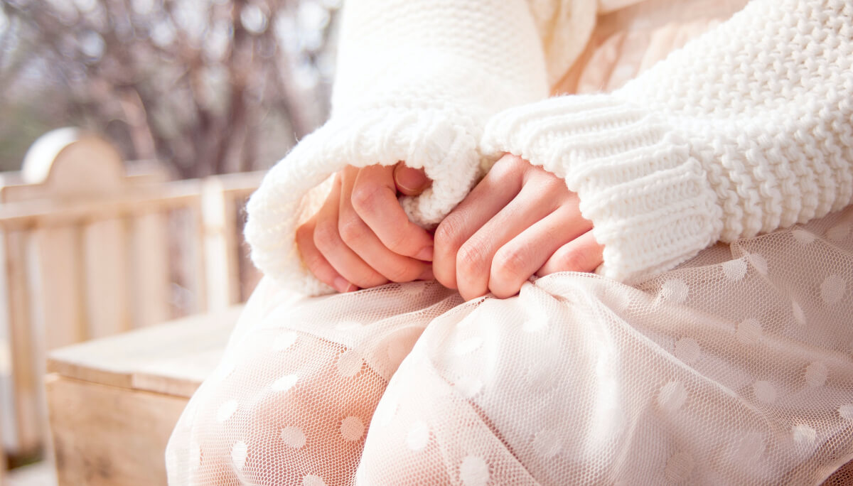 person's hands on lap in relaxed state