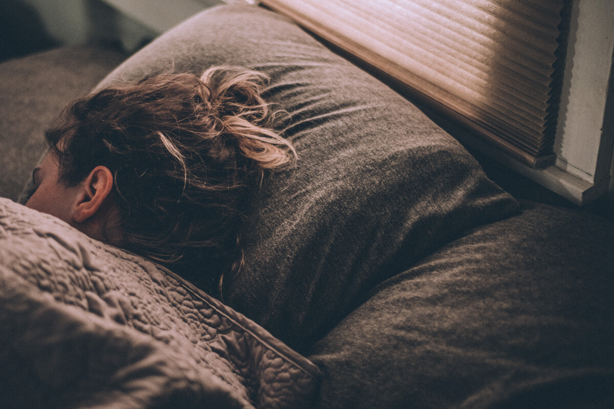 woman sleeping soundly in bed after digital detox