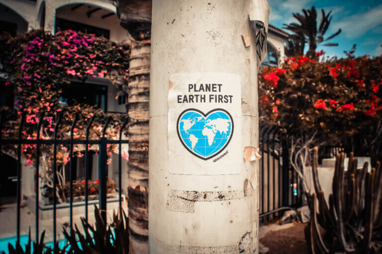 planet earth first poster on pillar promoting eco-friendly companies