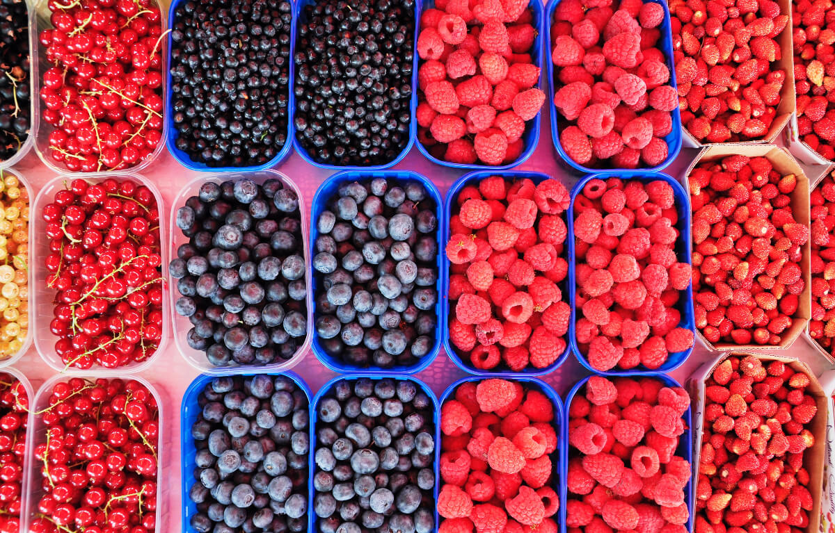 baskets of different berries that are part of healthy eating tips