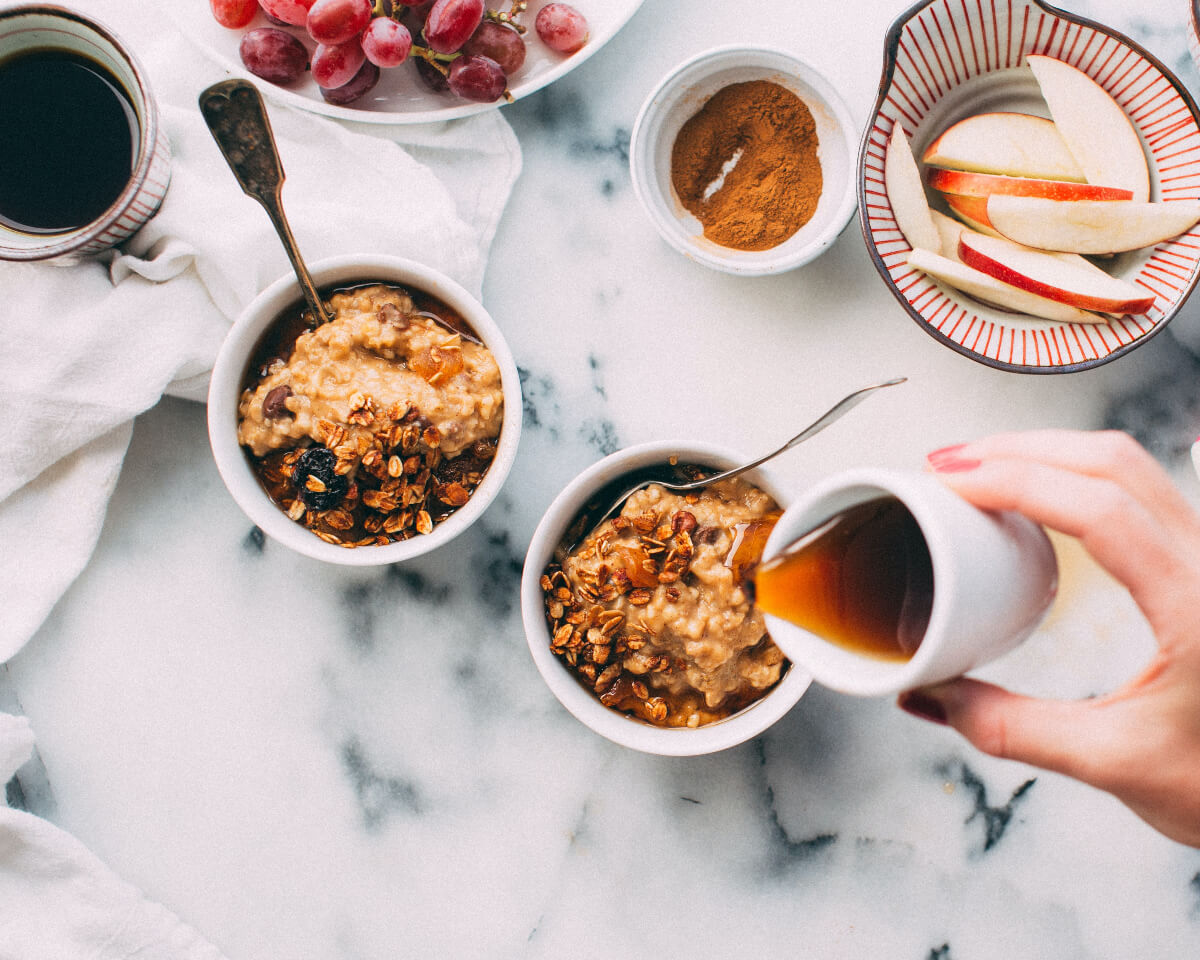 bowls of oatmeal. cinnamon and sliced applies 