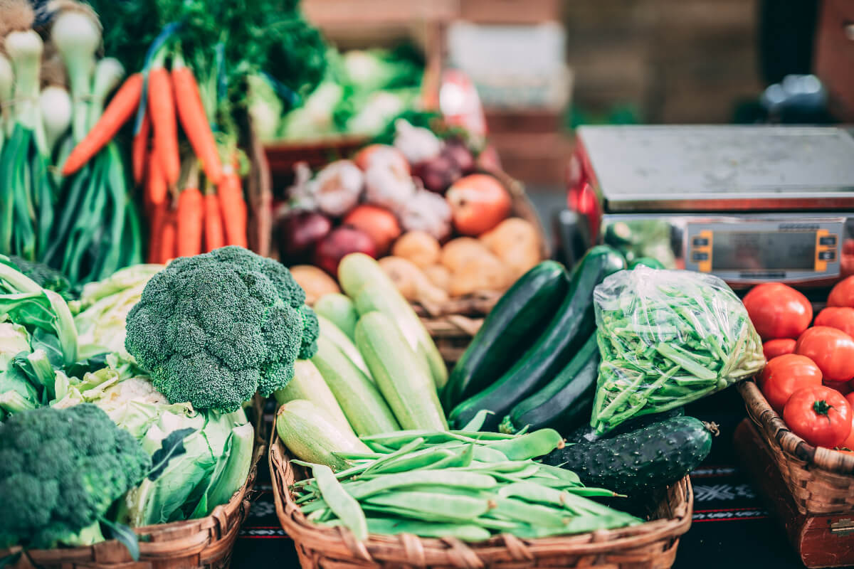 a variety of raw vegetables in baskets