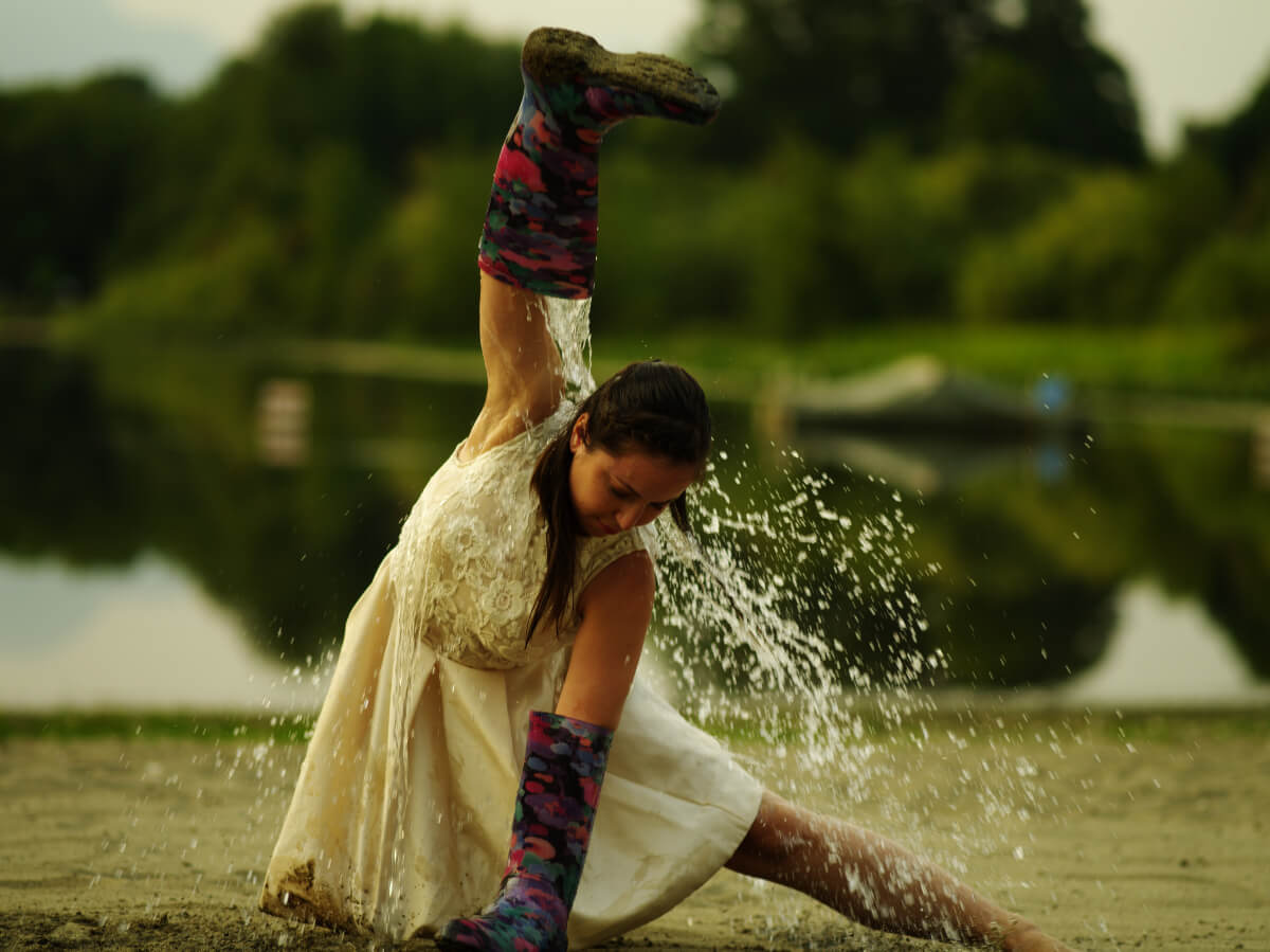 woman dancing out side in rain as part of immersive theatre production