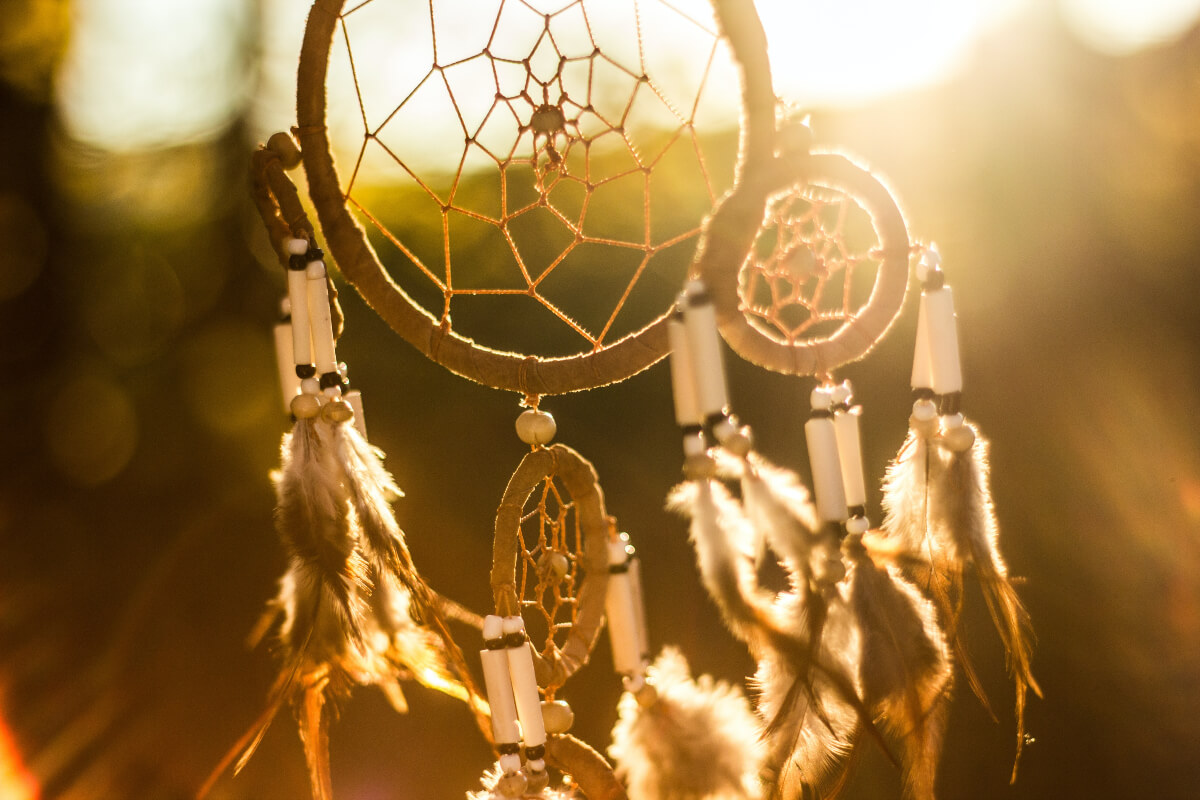 sun shining through an indigenous dream catcher 