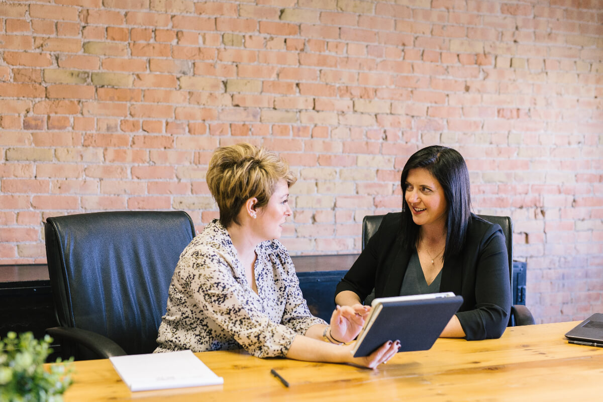 Two colleagues discussing pay transparency 