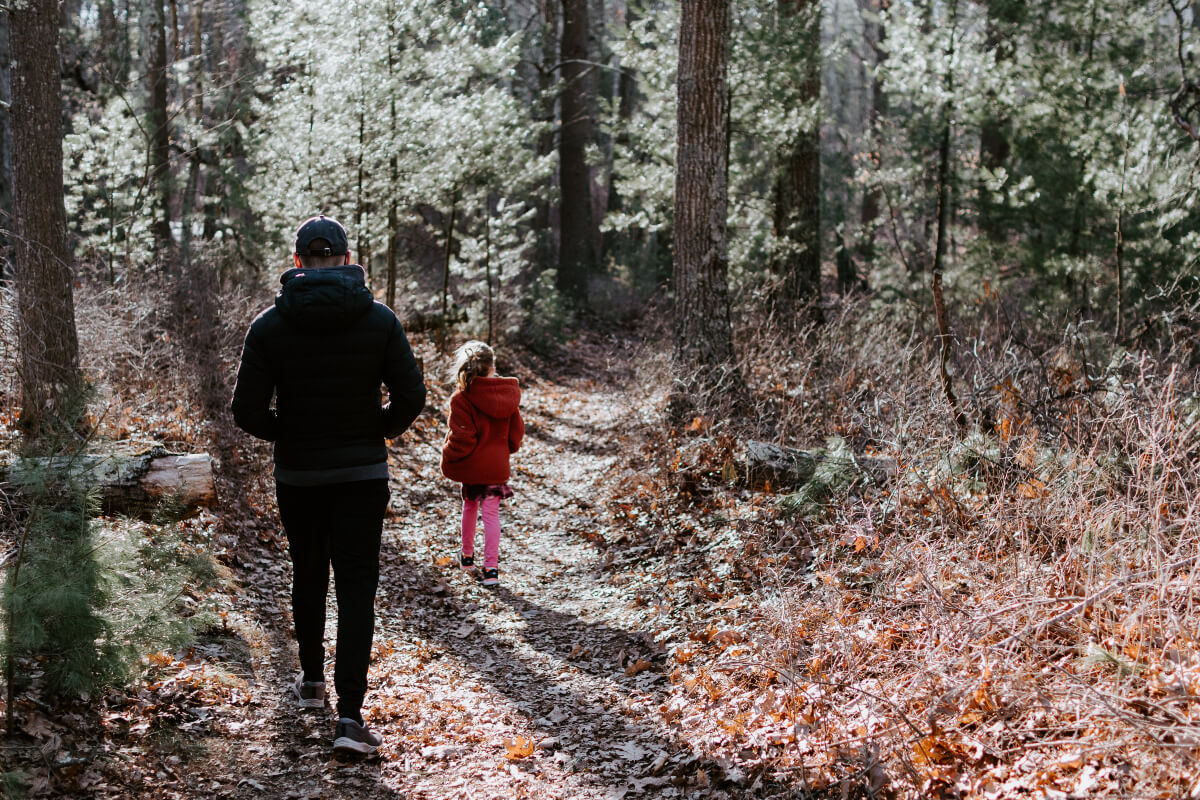 Father and daughter walking in a forest