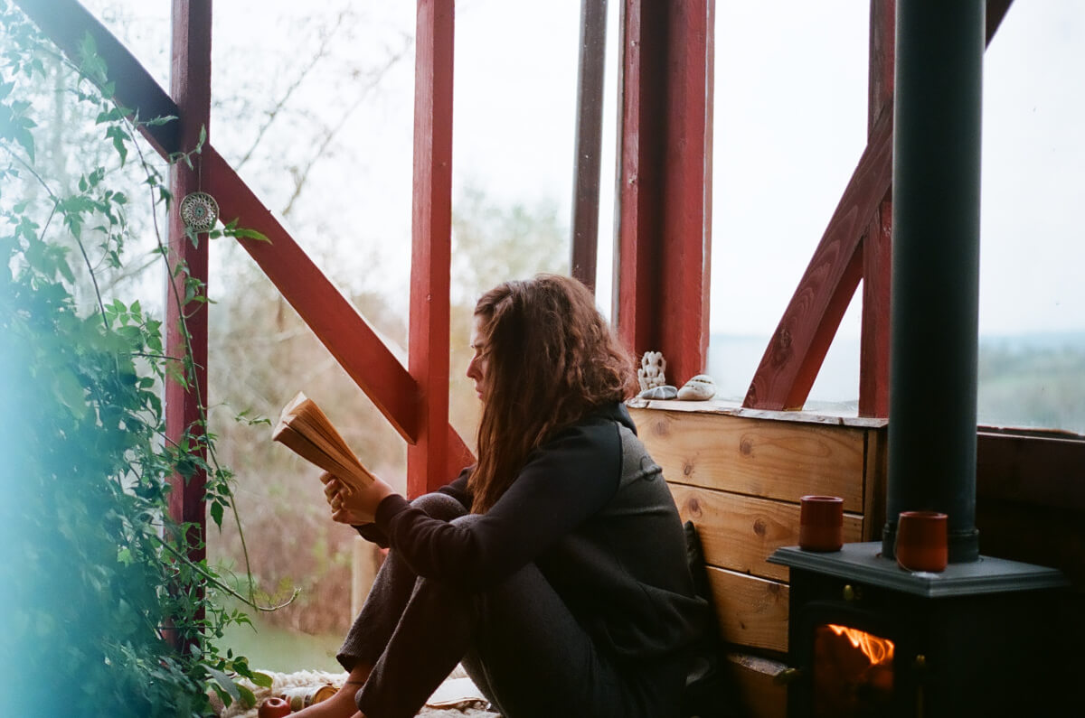 Woman reading a book outdoors 