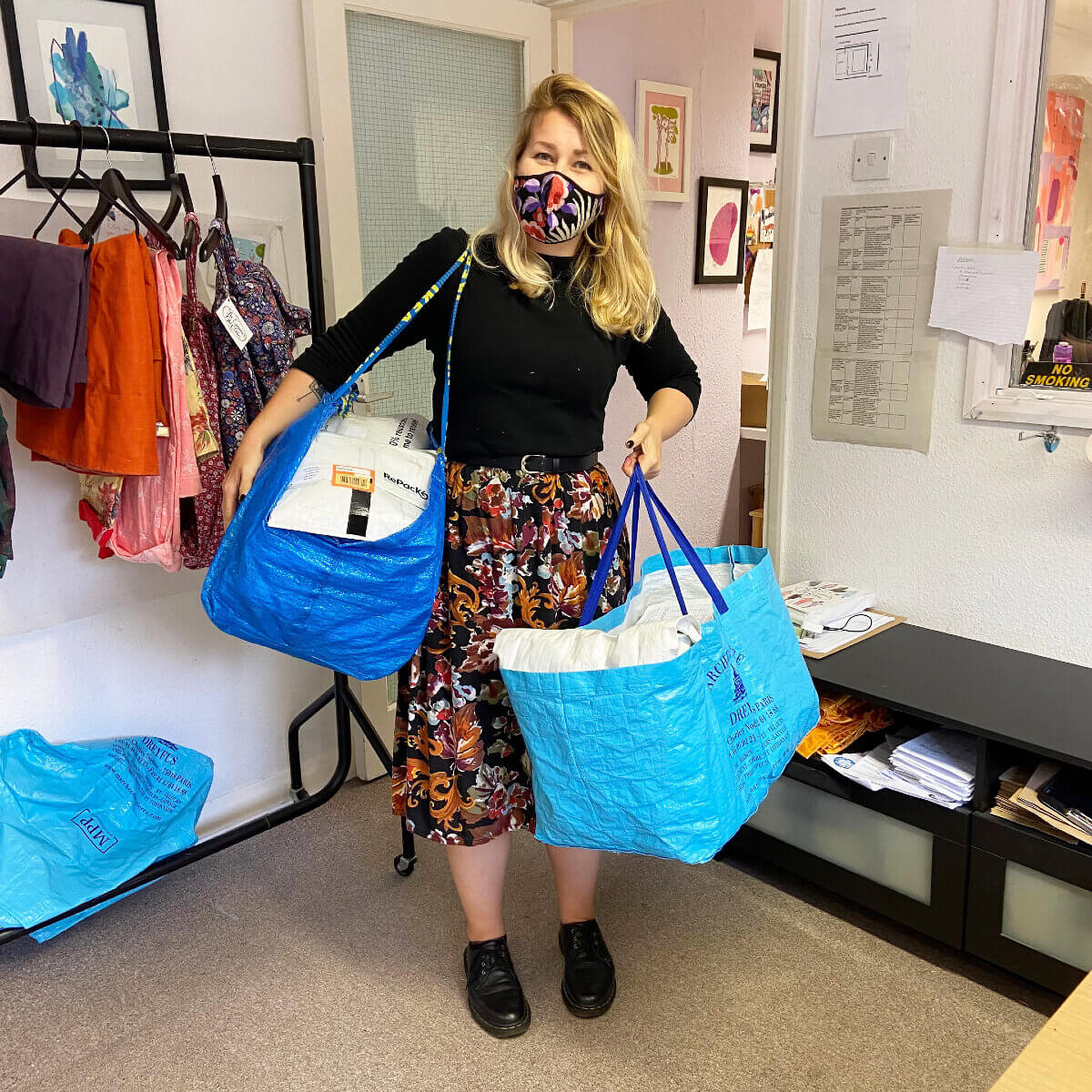 Anna, an Emperor’s Old Clothes employee, on her way out the door with a week’s worth of postage to ship out ethical clothing. 