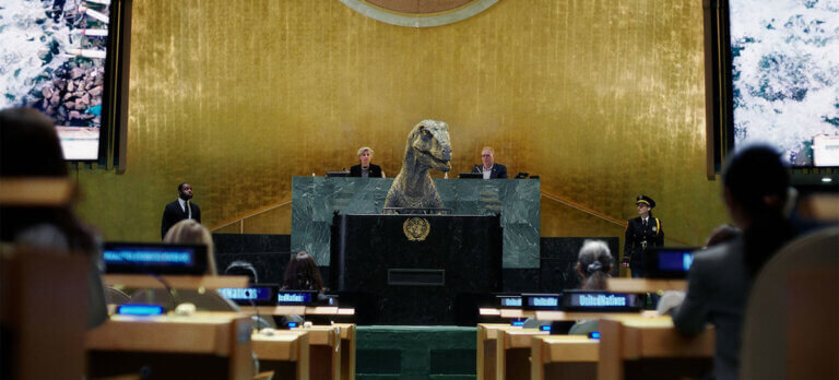 UN talking dinosaur standing at the podium.
