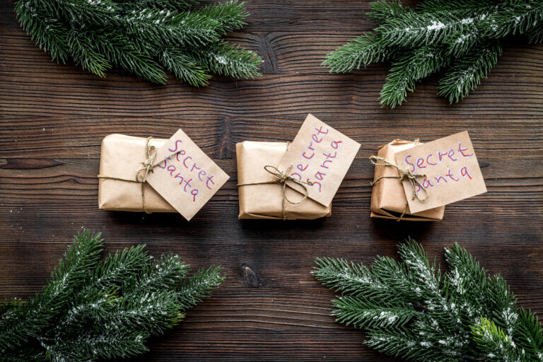Cute Secret Santa gifts wrapped in brown paper and tied with string.