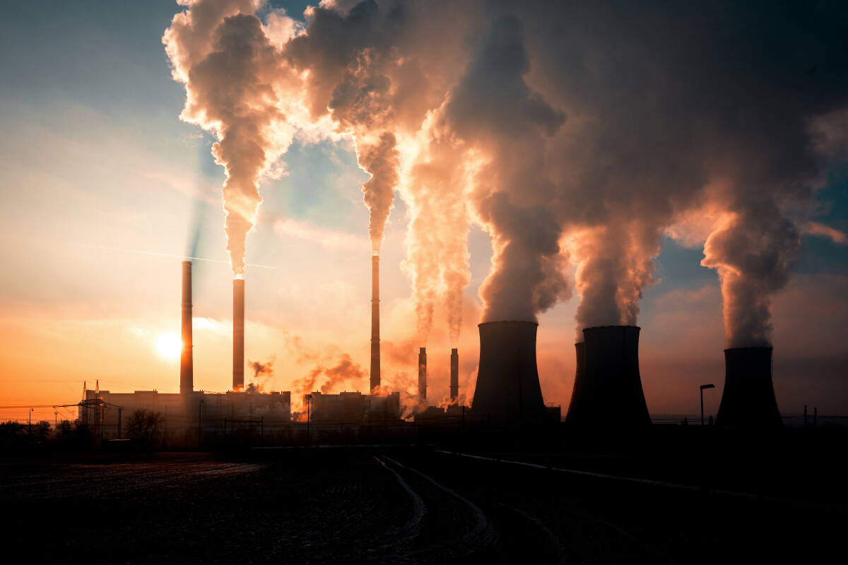 Smoke billows out of factory stacks. 