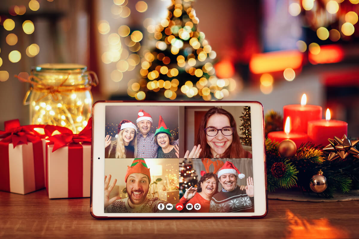 Family members having a holiday video chat wearing Christmas hats and sweaters 