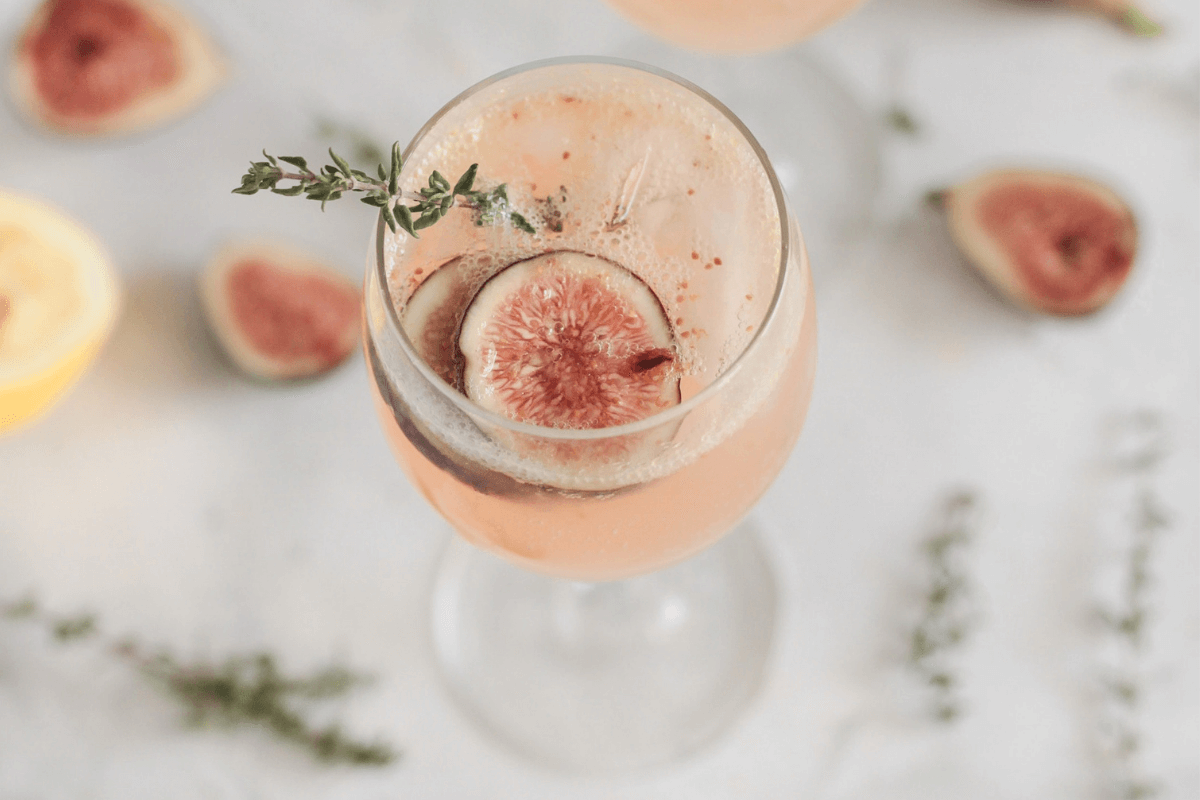 Champagne cocktail with fig-infused vodka, decorated with figs 