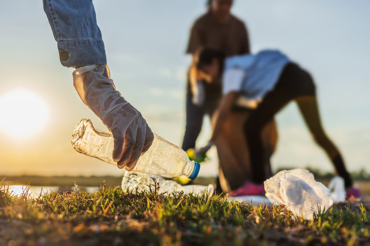 People picking up litter on the beach, a way to give back in the new year.  