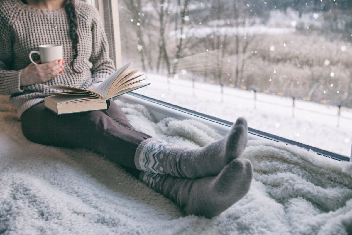 Person reading a book wearing cozy winter socks