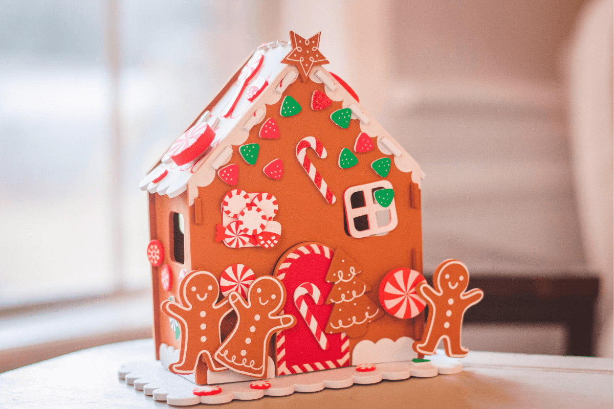 Gingerbread house decorated with gingerbread people and candy canes - a delicious and competitive winter date idea 