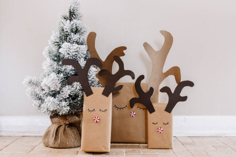 Eco-friendly Christmas ideas include wrapping gifts in eco-friendly materials. Pictured are gifts wrapped in brown paper decorated with reindeer antlers.