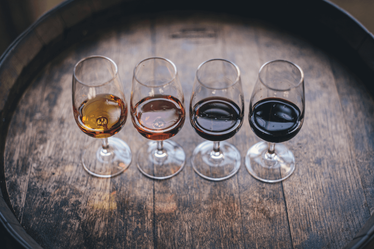 Glasses of different wines lined up for an at-home wine tasting date night