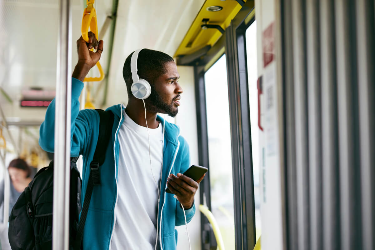 African Canadian listening to podcast on public transit.