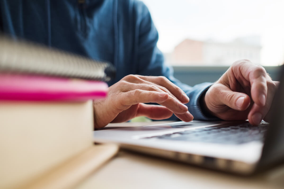 View of hands typing a laptop. There are online courses that teach how to live a more sustainable lifestyle. 
