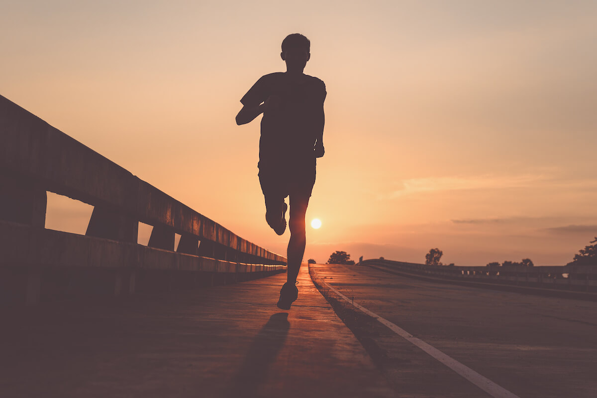 Athlete runner feet running on road, Jogging at outdoors. Man running for exercise.Sports and healthy lifestyle concept.