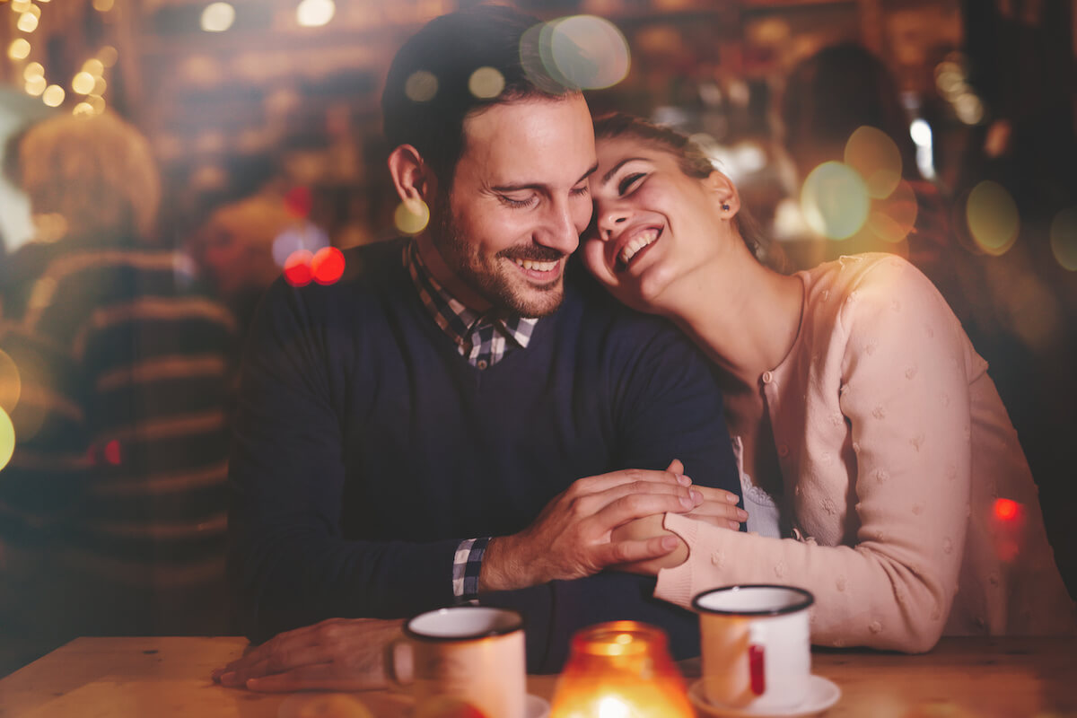 Romantic couple dating in pub at night