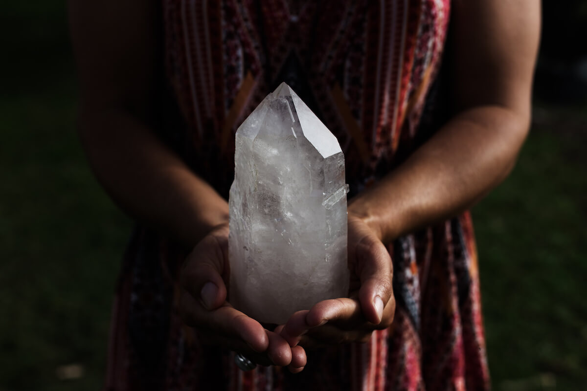 Closeup of woman holding a large pointed crystal