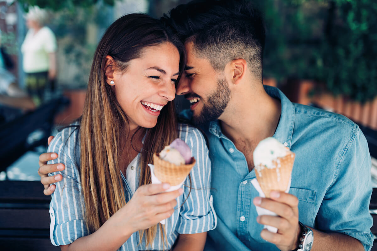 Happy young couple having date and eating ice cream