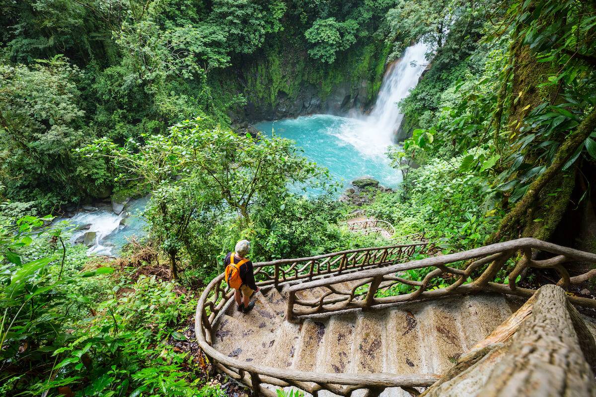 Majestic waterfall in the rainforest jungle of Costa Rica. Tropical hike.