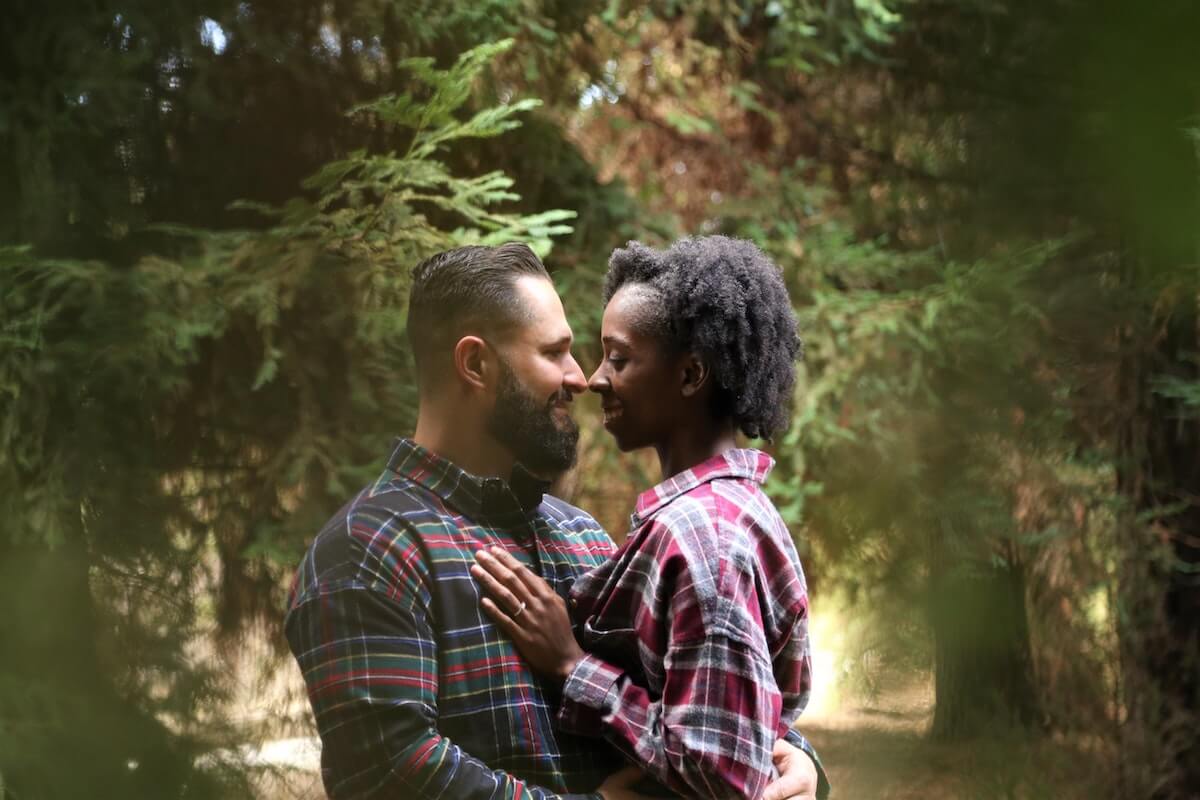 a couple embracing in a forest