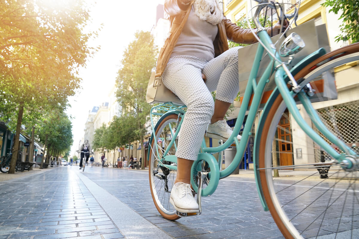 Senior woman riding city bike in town