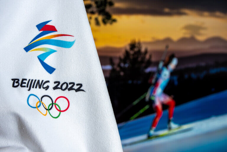 BEIJING, CHINA, JANUARY 1, 2022: Background for winter olympic game in Beijing 2022. Female biathlon athlete in night. Sport photo in background