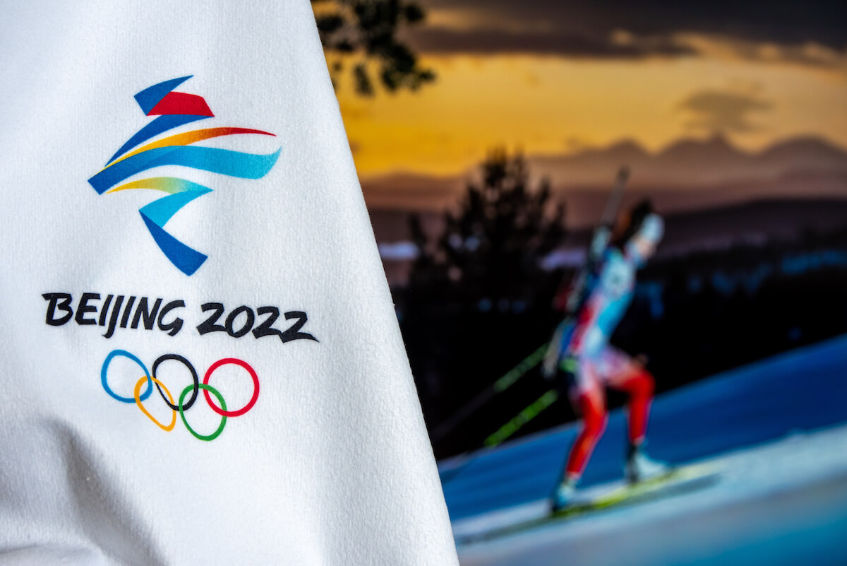 BEIJING, CHINA, JANUARY 1, 2022: Background for winter olympic game in Beijing 2022. Female biathlon athlete in night. Sport photo in background