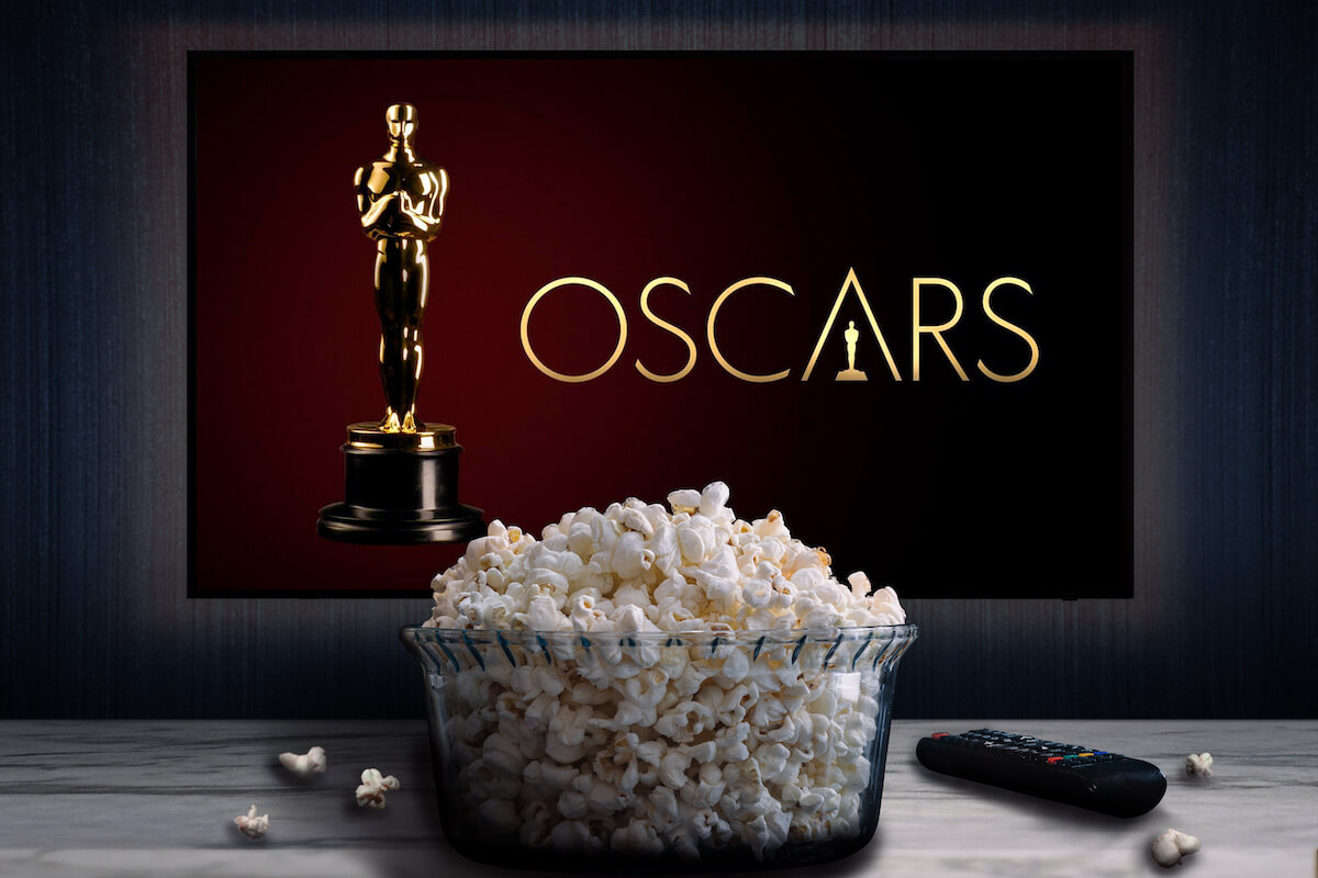 Cali, Colombia - March 24 2022: Oscars logo on tv screen behind a bowl of popcorn and a remote control.