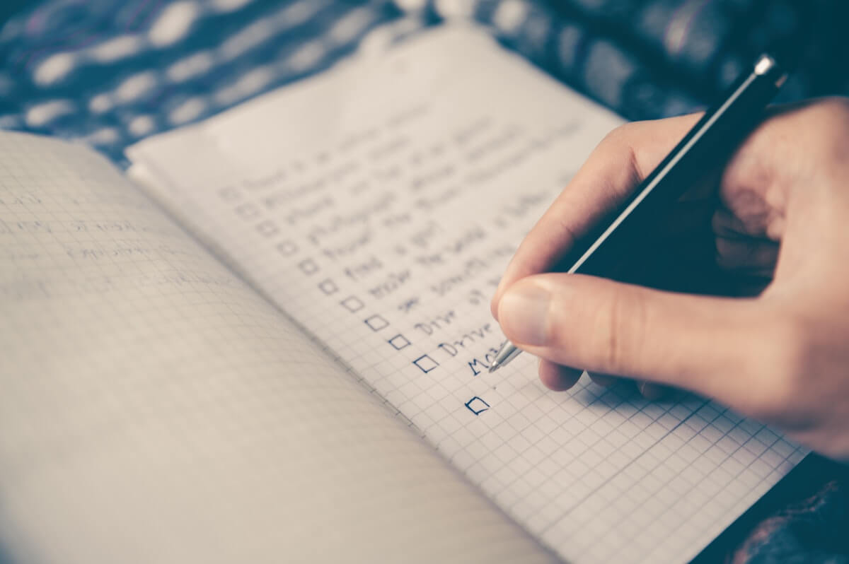 closeup of a hand making a checklist