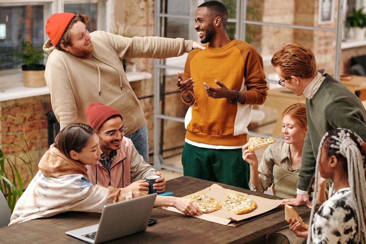 A group of friends hanging out and eating pizza