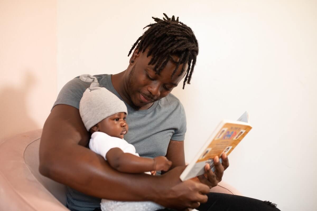 Male reading to his baby