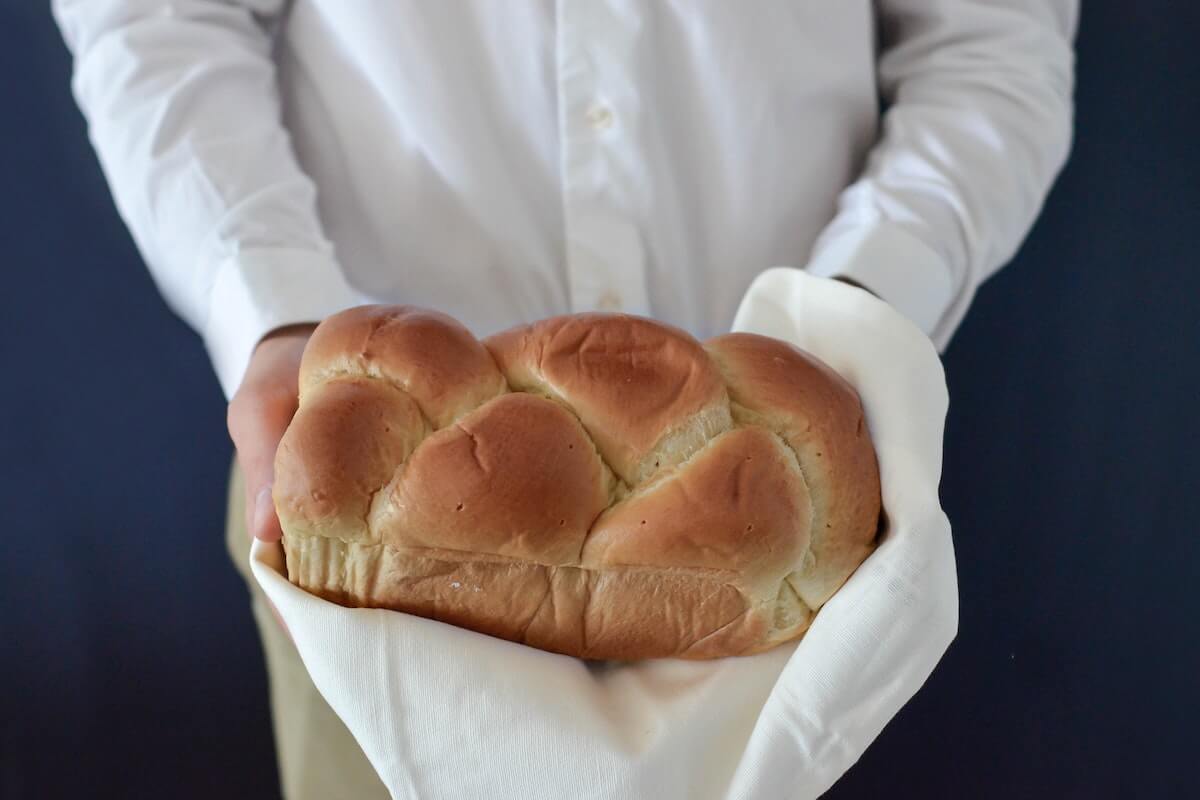 Closeup of someone holding bread. Photo by Element 5 Digital via Unsplash. 
