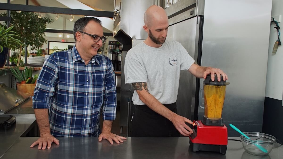 John Catucci watching the magic happen at The Grounds Café on the third season of Big Food Bucket List. Photo courtesy of Food Network Canada.  
