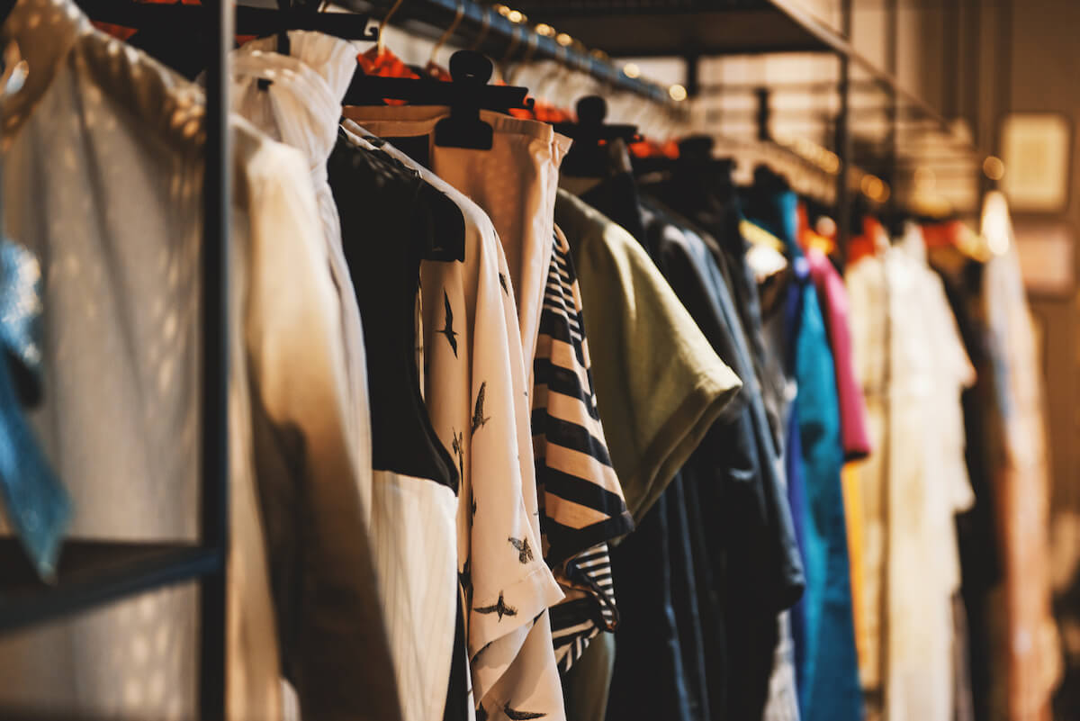 Clothes on racks in a fashion boutique.