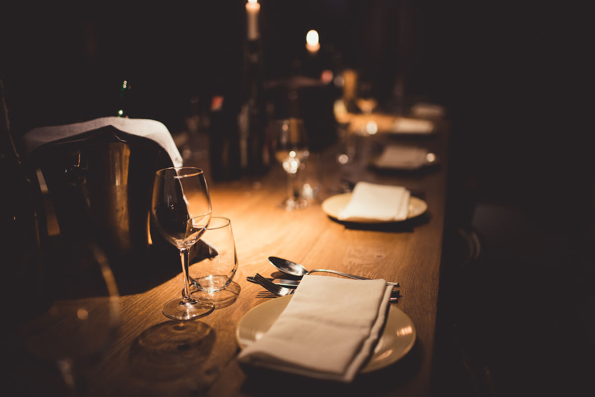 Fine dining table set up in the dim light.