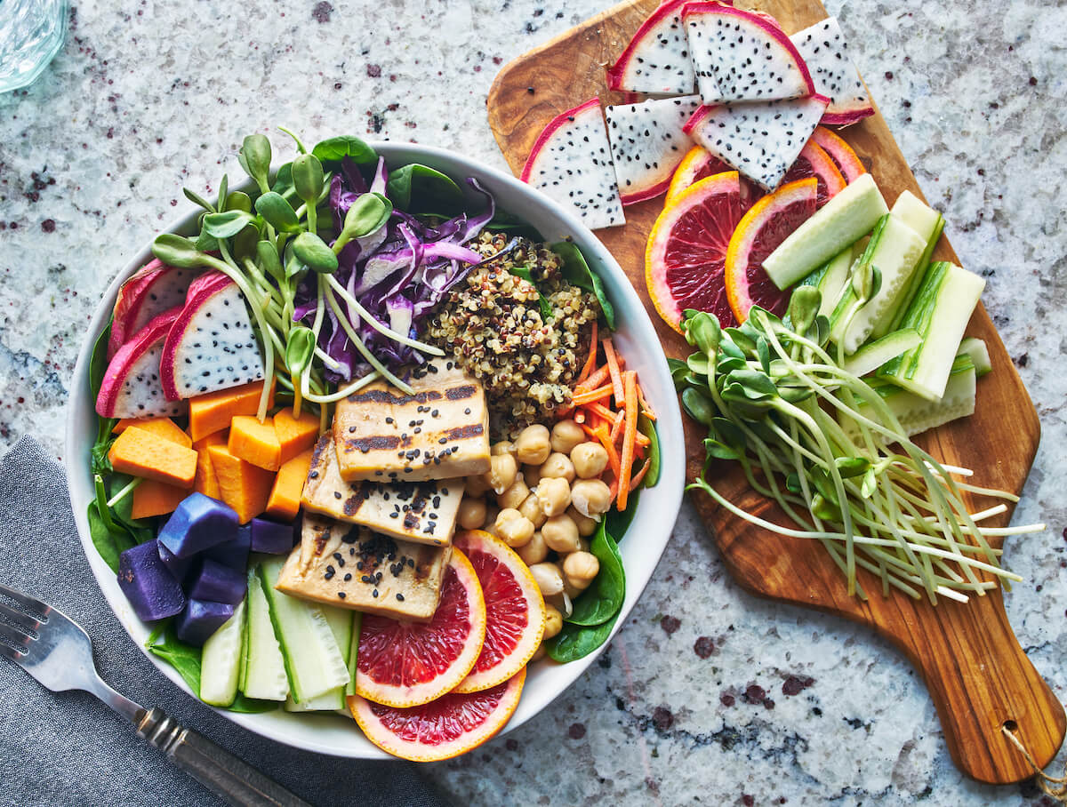 Grilled tofu and dragon fruit buddha bowl top view.