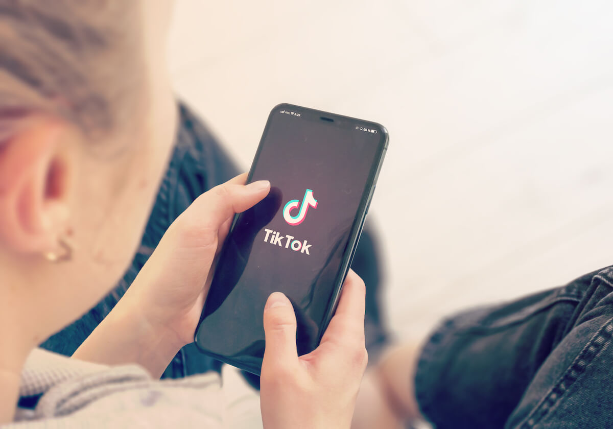 Young Girl Pointing or Texting Tiktok on Smart Phone During a Pandemic Self-Isolation and Coronavirus