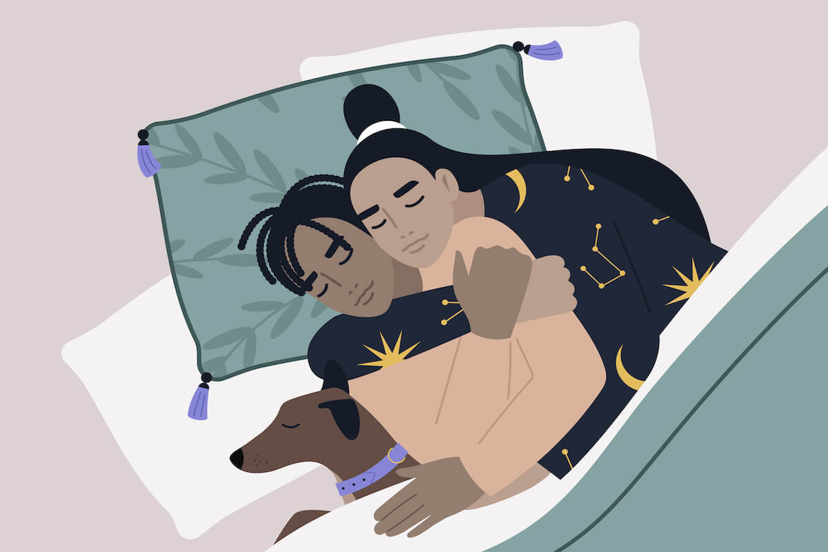 A top view of an interracial couple sleeping with their pet, a cozy home atmosphere