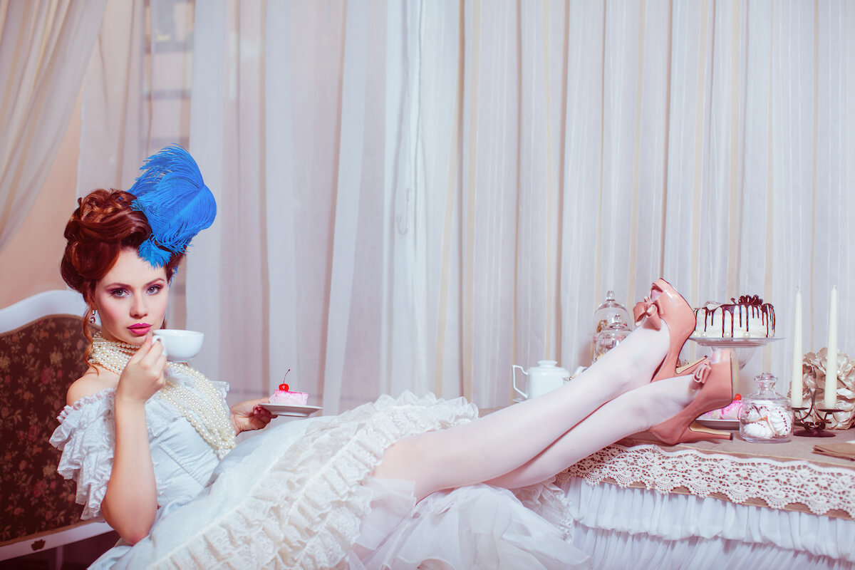 A lady in vintage dress drinking tea