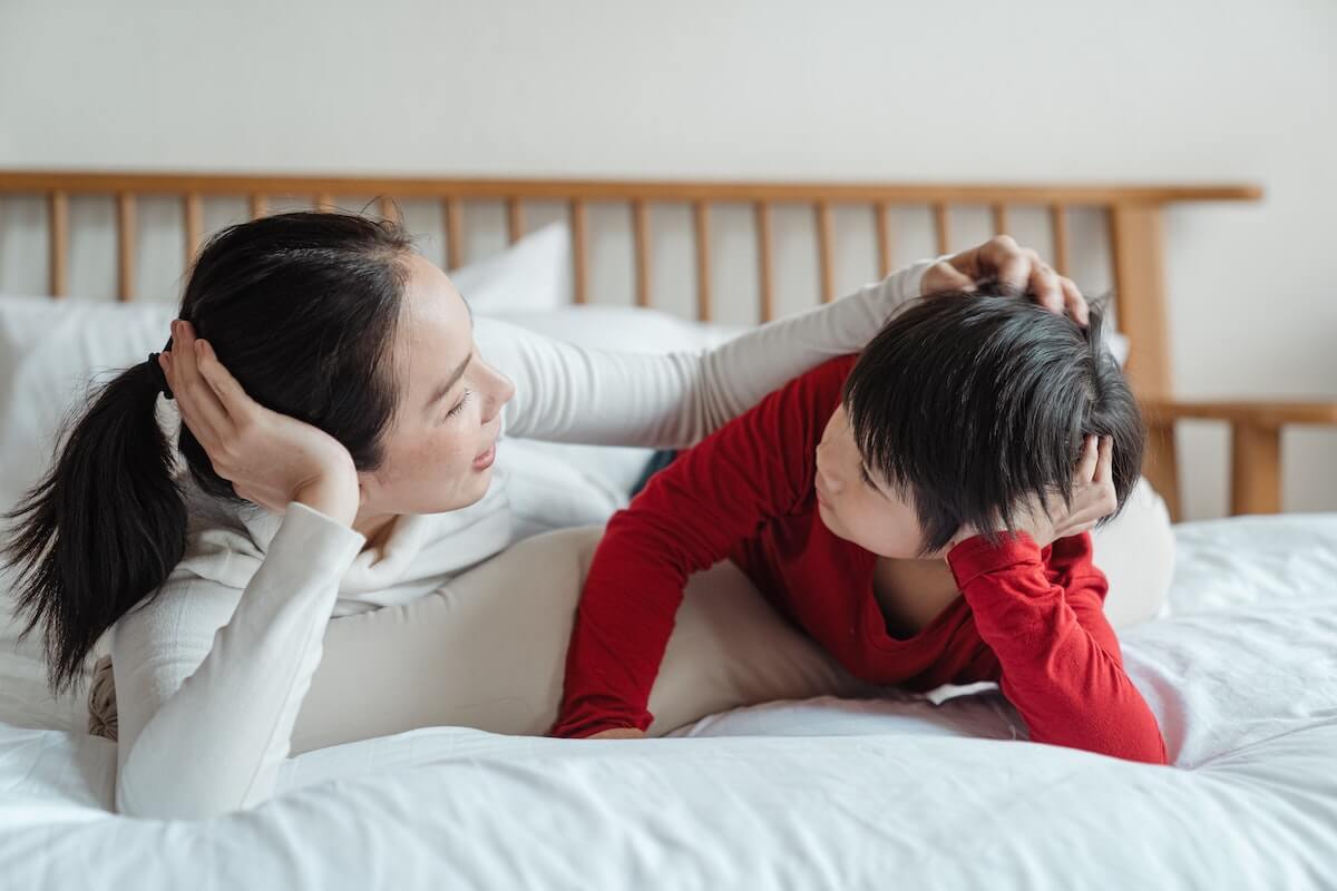 Mother talking to son in the room.