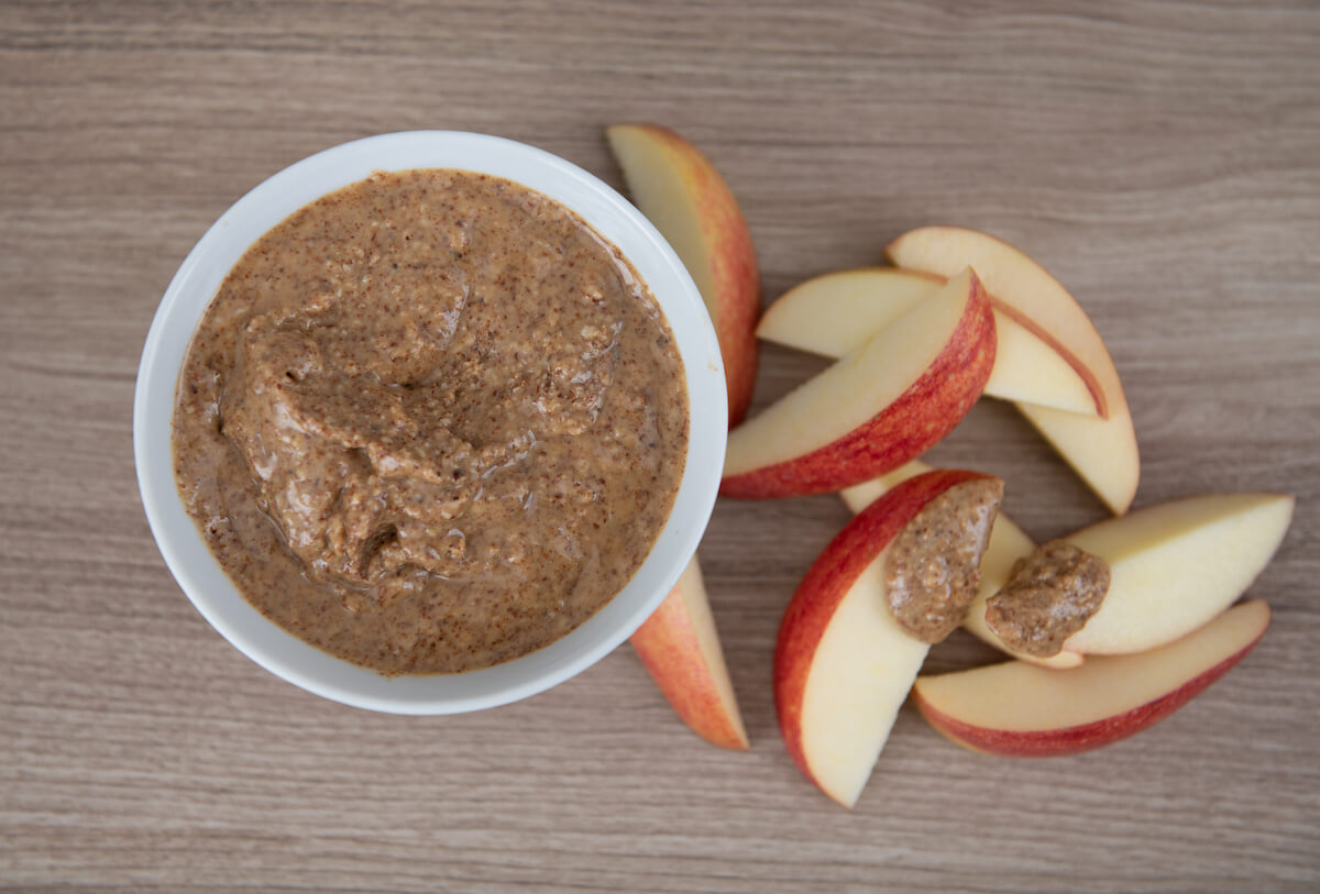 Top view of almond butter with apple slices