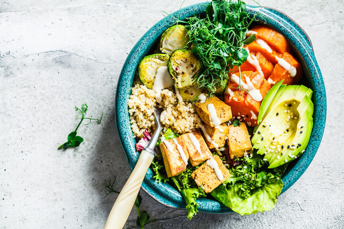 Buddha bowl with quinoa, tofu, avocado, sweet potato, brussels sprouts and tahini