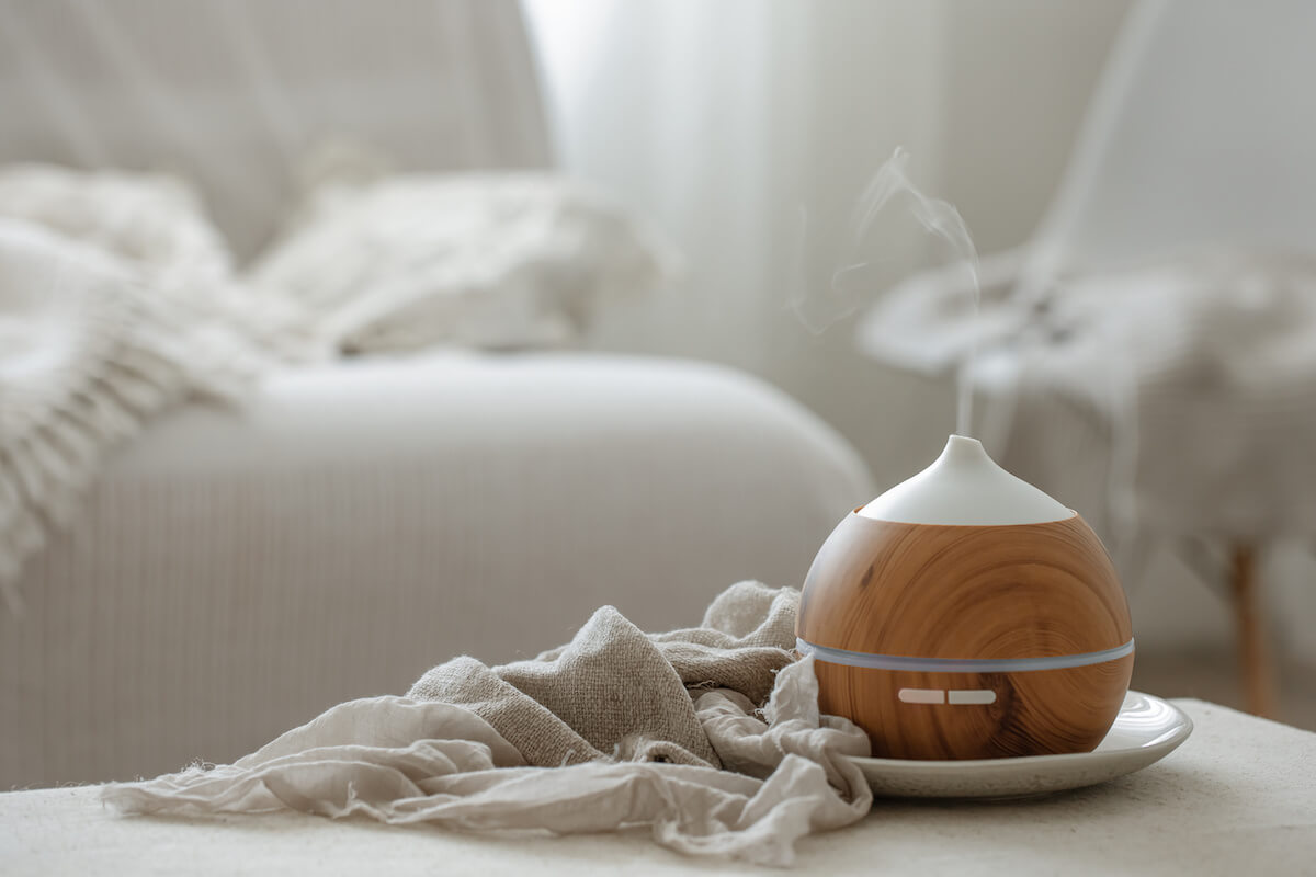 Essential oil aroma diffuser humidifier diffusing water articles in the air.